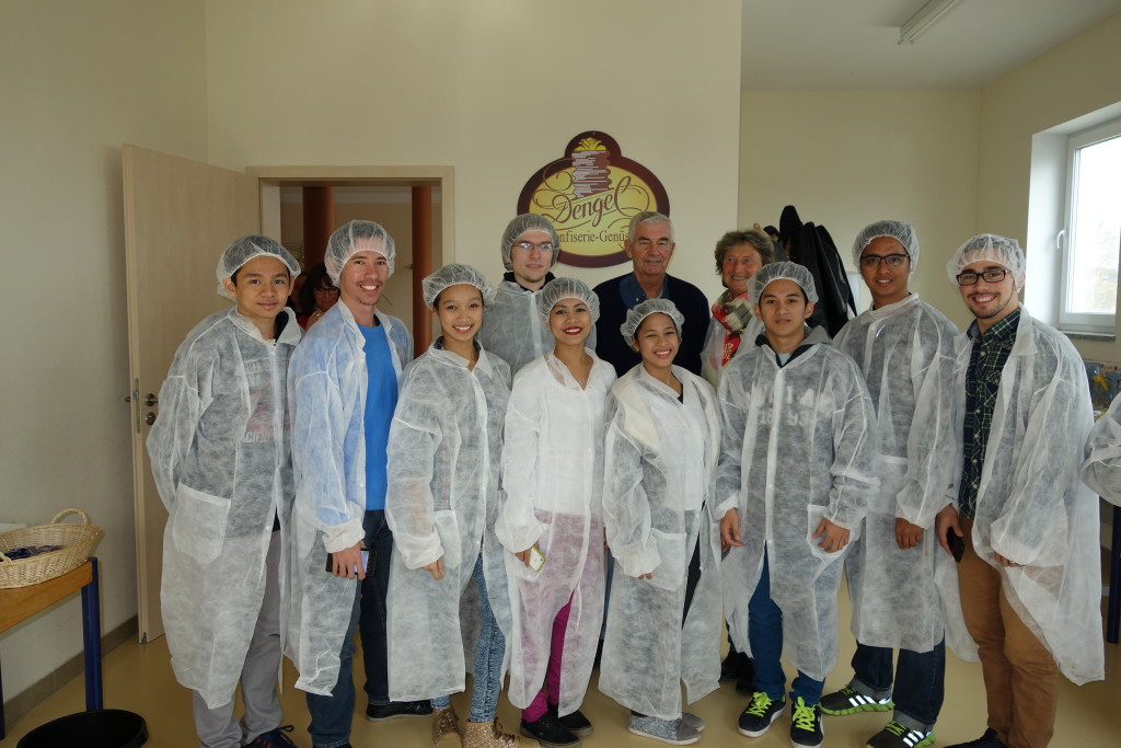 Rosemarie beside Fr. Shay and Felix Brockling with the Akbay-Preda Theatre group at the chocolate factory where the special Fair Trade chocolate is made. 