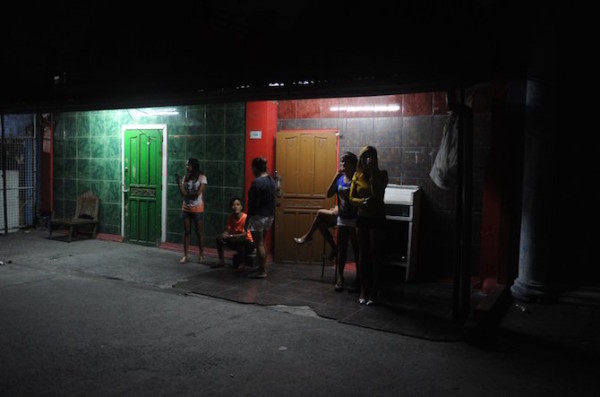 In this photo taken November 5, 2014, shows bar girls waiting for customers in the thriving red light district of Angeles City, north of Manila. Wealthy British banker Rurik Jutting charged over grisly twin murders in Hong Kong, was a regular in a shabby red-light district of the Philippines where he liked to flash his cash and was treated like a king. AFP PHOTO / Jay DIRECTO