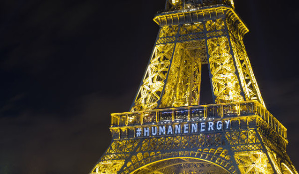 epa05057210 The front of the Eiffel Tower bears the message 'Human Energy' as part of a light installation entitled 'Human Energy' by artist Yann Toma drawing attention to human-generated power, on the sidelines of the COP21 Climate Conference, in Paris, France, 06 December 2015. The 21st Conference of the Parties (COP21) is held in Paris from 30 November to 11 December aimed at reaching an international agreement to limit greenhouse gas emissions and curtail climate change.  EPA/IAN LANGSDON