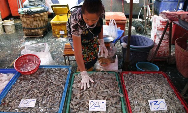  fish-seller sorts shrimp at Klong Toey market in Bangkok. Activists claim that government measures have failed to end labour abuses in Thailand’s seafood industry. Photograph: Barbara Walton/EPA
