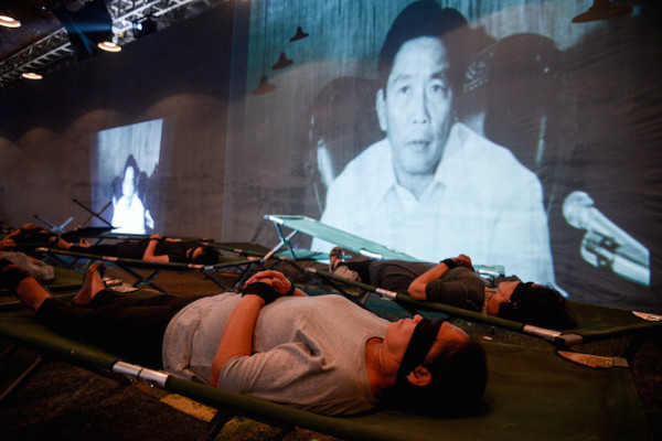 In one of the museums haunting exhibits, participants lie motionless and are bound and blindfolded where a recording is played of the late dictator Ferdinand Marcos declaring martial law. (Photo by Eloisa Lopez)