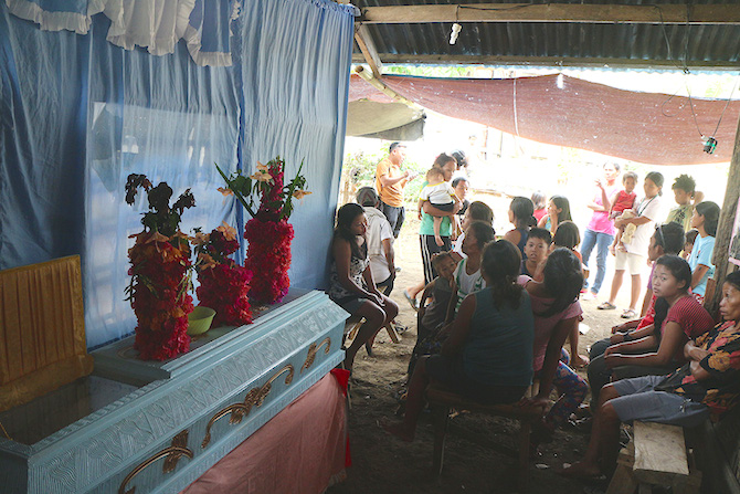 Relatives and neighbors attend the wake of Manobo farmer Lito Salon at their house in Brgy Malibatuan, Arakan, North Cotabato on Tuesday, April 5. Allan, Lito’s brother said they went to Kidapawan March 29, thinking they would get a sack of rice each. They returned home March 31, a day before the violent dispersal, after Lito complained of headache and back pains. Lito’s wife Margarita said her husband was rushed to the Antipas District hospital on April 3 and died on April 4. KEITH BACONGCO
