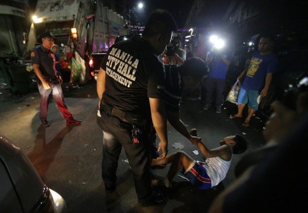 In this Wednesday June 8, 2016 photo, a Filipino boys cries as he is apprehended by a social worker and police for violating a night to dawn curfew for minors in Manila, Philippines. In a crackdown, dubbed “Oplan Rody,” bearing Duterte’s name, police rounded up hundreds of children or their parents to enforce a night curfew for minors, and taken away drunk and shirtless men roaming metropolitan Manila’s slums. The poor, who were among Duterte’s strongest supporters, are getting a foretaste of the war against crime he has vowed to wage. AP