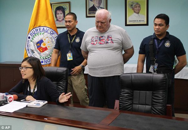 Jailed: Slade is presented to reporters by Immigration spokeswoman Elaine Tan in Manila, Philippines on June 4, 2015