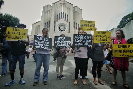 Members of the ecumenical group Promotion of Church Peoples' Response call on the government to observe human rights in the war against illegal drugs during a demonstration outside a Catholic church in Manila. (Photo by Vincent Go)