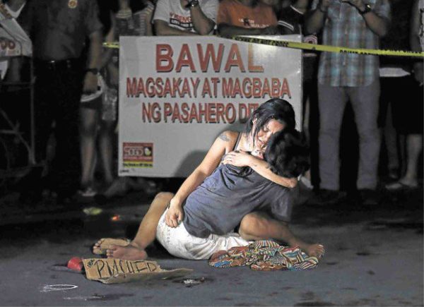 LAMENTATION A weeping Jennelyn Olaires hugs partner Michael Siaron, 30, a pedicab driver and alleged drug pusher, who was shot and killed by motorcycle-riding gunmen near Pasay Rotonda on Edsa. He was one of six killed in drug-related incidents in Pasay and Manila yesterday. RAFFY LERMA/INQUIRER FILE PHOTO