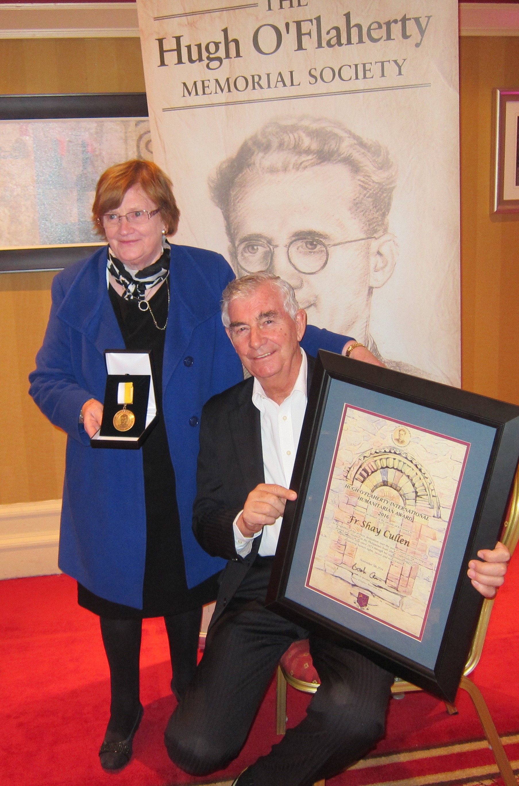 The grand niece of Mons.Hugh O'Flaherty presents the Mons.Hugh O'Flaherty International Humanitarian Award medal and plaque to Father Shay Cullen,of the Preda Foundation which he founded in 1974 to save women and children from jails, abusers and human traffickers. The award was presented in Killarney, Ireland on 5 November 2016 