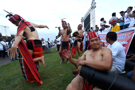 Tribal people from the northern Philippines play music at the 'Walk for Like' in Manila on Feb. 18. (Photo by Angie de Silva)