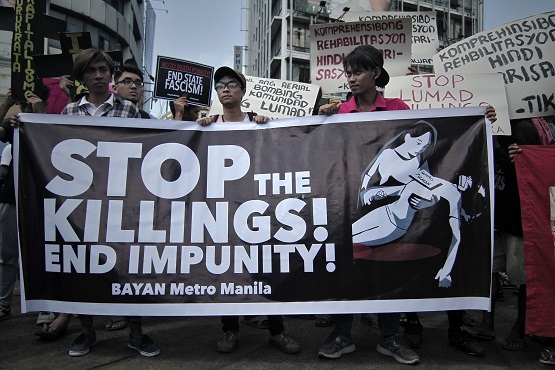 Filipino activists call for a stop to drug-related killings during a protest march in time for the observance of Holy Week. (Photo by Vincent Go)