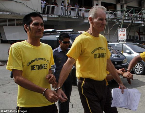 Australian accused paedophile Peter Scully (right) faces a number of serious charges in the Phillipines, including murdering a 12-year-old girl, multiple counts of sexual abuse, torture, rape and human trafficking 