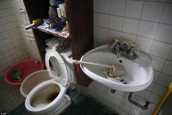 Underwear is seen wedged behind the faucet of the sink in the bathroom of the American man's home in the Philippines