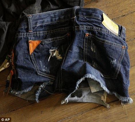 Children's clothing is seen scattered across the floor of the alleged child webcam cybersex operator's home 