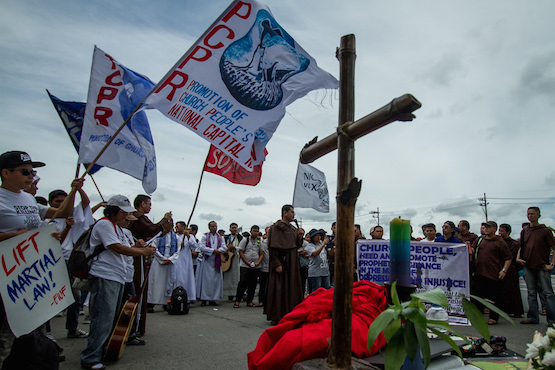 Church groups stage a protest rally outside the Philippine Congress building in Manila as President Rodrigo Duterte delivers his State of the Nation Address on July 24. (Photo by Mark Saludes)