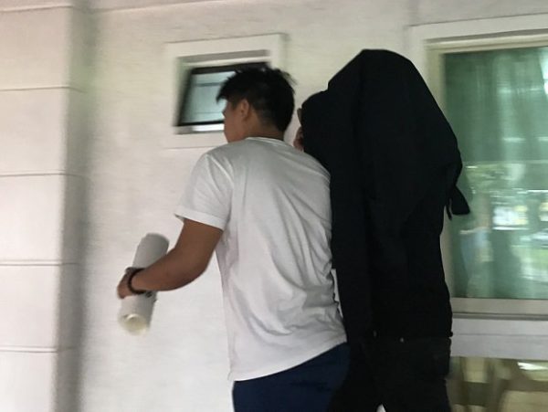 Monsignor Arnel Lagarejos (covered in black jacket) is escorted out of the Marikina City Prosecutor’s Office after he was charged with violation of Anti-Trafficking in Persons Act on Saturday, July 29, 2017. PHILIPPINE DAILY INQUIRER / JODEE AGONCILLO