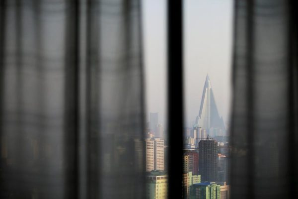 FILE PHOTO: The 105-storey Ryugyong Hotel, the highest building under construction in North Korea, is seen from inside another hotel's room in Pyongyang, North Korea May 7, 2016.