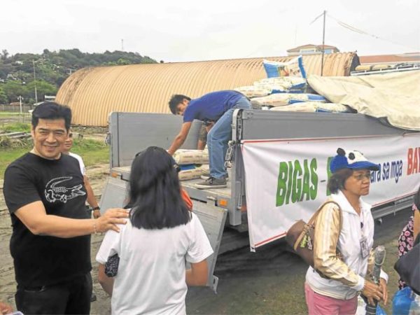 Subic Bay Metropolitan Authority Chair Martin Diño leads the distribution of rice to some 200 workers inside the Subic Bay Freeport. —ALLAN MACATUNO