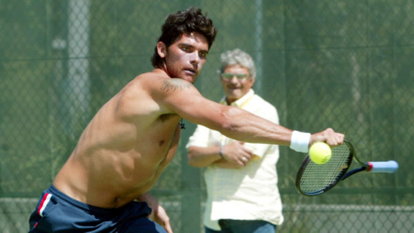 Mark Philippoussis during practise in Sydney, as his father looks on