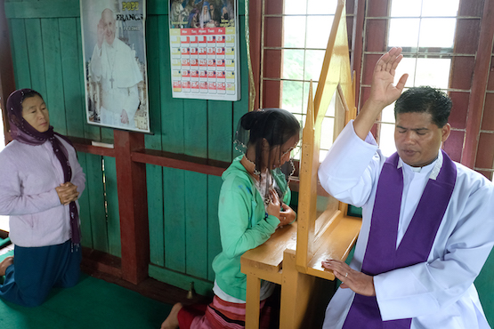 A priest hears confession in Shan State, Myanmar. There are about 700,000 Catholics in the Buddhist-majority country. (ucanews.com photo)