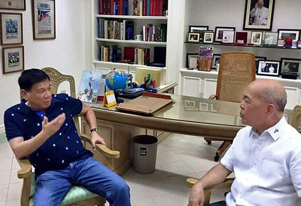 In this Dec. 4, 2015 photo, then presidential candidate Rodrigo Duterte speaks with Davao Archbishop Romulo Valles days after his controversial speech where he complained about Pope Francis’ visit in the Philippines.