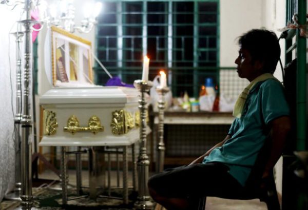 LONG NIGHT A grieving Eduardo Gabriel holds a silent vigil on the first night of the wake of his son Reynaldo “Kulot” de Guzman at the mortuary of the Barangay Hall of San Andres in Cainta, Rizal. The body of the 14-year-old De Guzman was thrown into the river in Gapan, Nueva Ecija. —RICHARD REYES