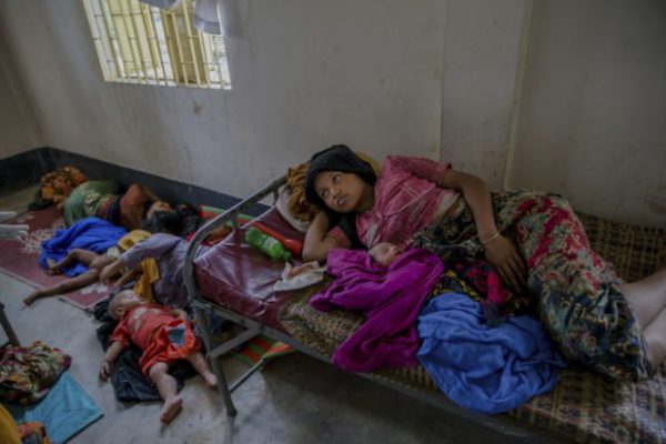 Newly arrived Rohingya women along with their children rest inside a health complex run by aid agencies in Kutupalong refugee camp, Bangladesh, Wednesday, Sept. 13, 2017. (AP Photo/Dar Yasin)