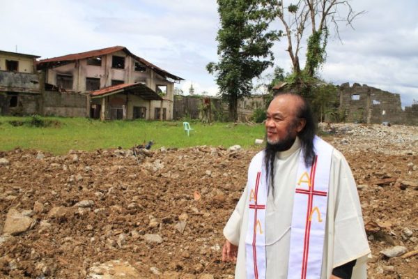 Father Teresito Soganub visits the site of the bishop’s residence in Marawi in July 2019. (File photo by Richelieu Umel)