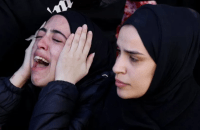 Palestinian teacher shot while giving first aid to militant